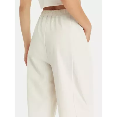 Pantalon femme Champion Wide Leg 117110-YS137 beige avec coupe large, taille haute élastique et logo Champion