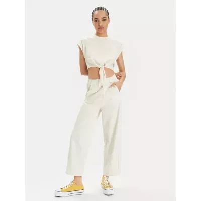 Pantalon femme Champion Wide Leg 117110-YS137 beige avec coupe large, taille haute élastique et logo Champion